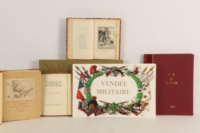 several books sitting on top of a white table next to each other