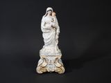 a white statue of a woman holding a child on a black background