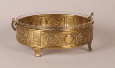 an antique brass bowl with handles and handles on a stand