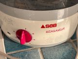 a close up of a white and red blender on a counter
