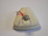 a ring that is sitting on top of a pillow