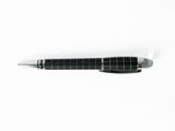 a pen that is laying on a white surface