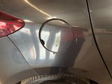 a close up of a car ' s rear end with a hole in it