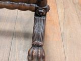 a close up of a wooden bench on a hard wood floor