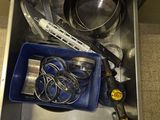 a metal drawer with a bunch of kitchen items inside of it