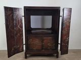 an old wooden cabinet with two doors open on a wooden floor