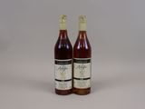 two bottles of wine sitting next to each other on a table