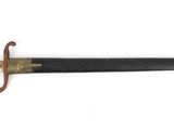an old sword with a wooden handle on a white surface
