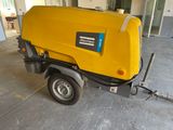 a small yellow machine that is parked in a garage