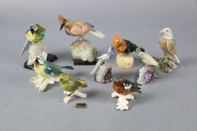a lot of small figurines of birds sitting on top of each other
