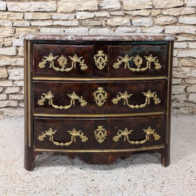 an antique chest of drawers with a marble top and gold decoration