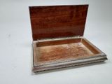a silver box with a wooden lid on a white table
