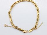 a gold chain bracelet with a clasp on a white background
