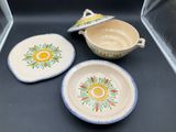 three plates and a bowl sitting on a table