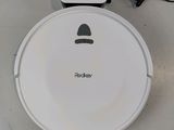 a robot that is sitting on the floor next to a charger