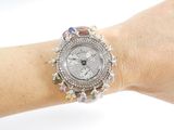 a woman ' s wrist that has a watch on it