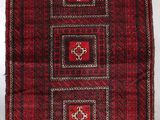 a red and black rug with four squares on it