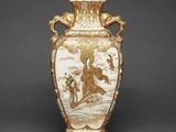 a vase with a painting on it on a table