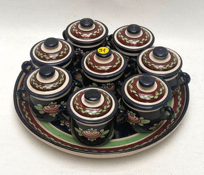 a plate with a lot of small cups and saucers on it