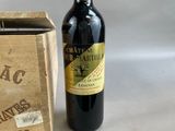 a bottle of wine sitting next to a wooden box