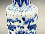 a blue and white vase sitting on a table