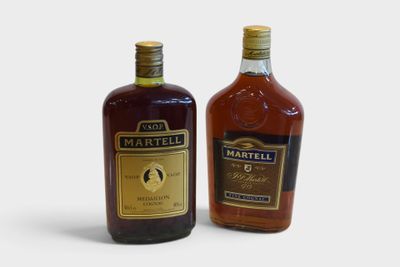 two bottles of whiskey sitting next to each other on a white surface