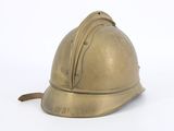 a gold helmet that is sitting on a white surface