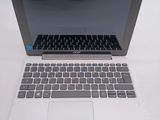 a laptop computer sitting on top of a white table