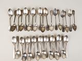 several spoons and spoon spoons are lined up on a white surface