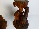 two wooden sculptures that are sitting on a table
