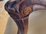 a close up of a wooden chair on a table