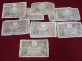 several different types of money laid out on a red table