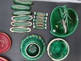 a lot of green and red dishes and bowls on the table