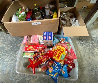 a box full of candy and candy bars on the floor