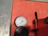 a close up of a gauge on a red machine