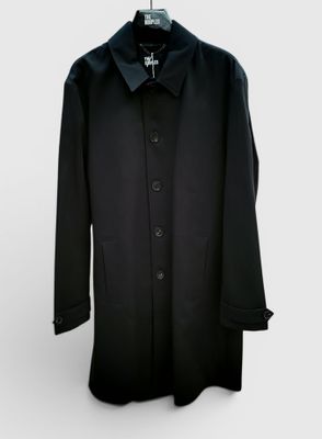 un manteau noir suspendu à un cintre sur fond blanc