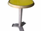 the table is made of metal and has a yellow table top