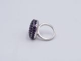 silver ring with purple stones on a white background
