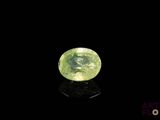 a close up of a green gemstone on a black surface