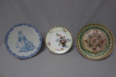 three plates with different designs on them sitting on a table