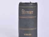 a black book that is sitting on a white surface