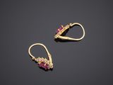 a pair of ruby and diamond earrings