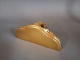 gold plated purse on white surface with white background