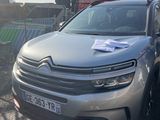 the citrole is parked on the side of the road in front of a fence