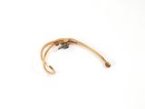 pair of gold tone cuff bracelets on white background
