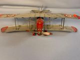 a toy airplane that is sitting on a white surface
