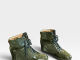 a pair of green shoes on a white surface