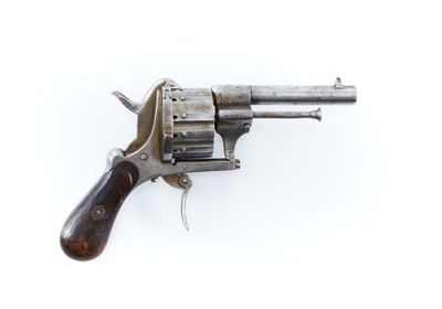 un vieux revolver avec un manche en bois sur fond blanc