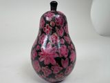 a black and pink vase sitting on a white table
