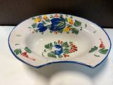a blue and white bowl with flowers on it on a table
